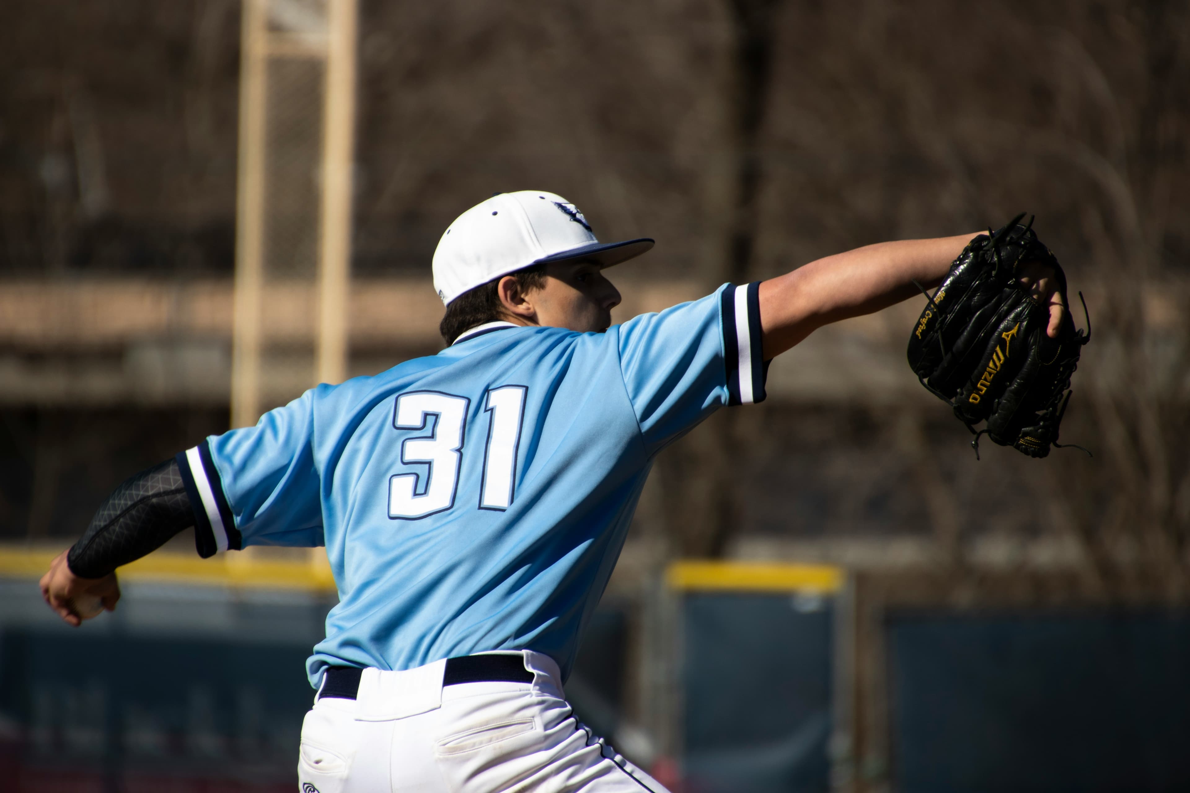 NJCAA baseball player in blue uniform at bat during a junior college game