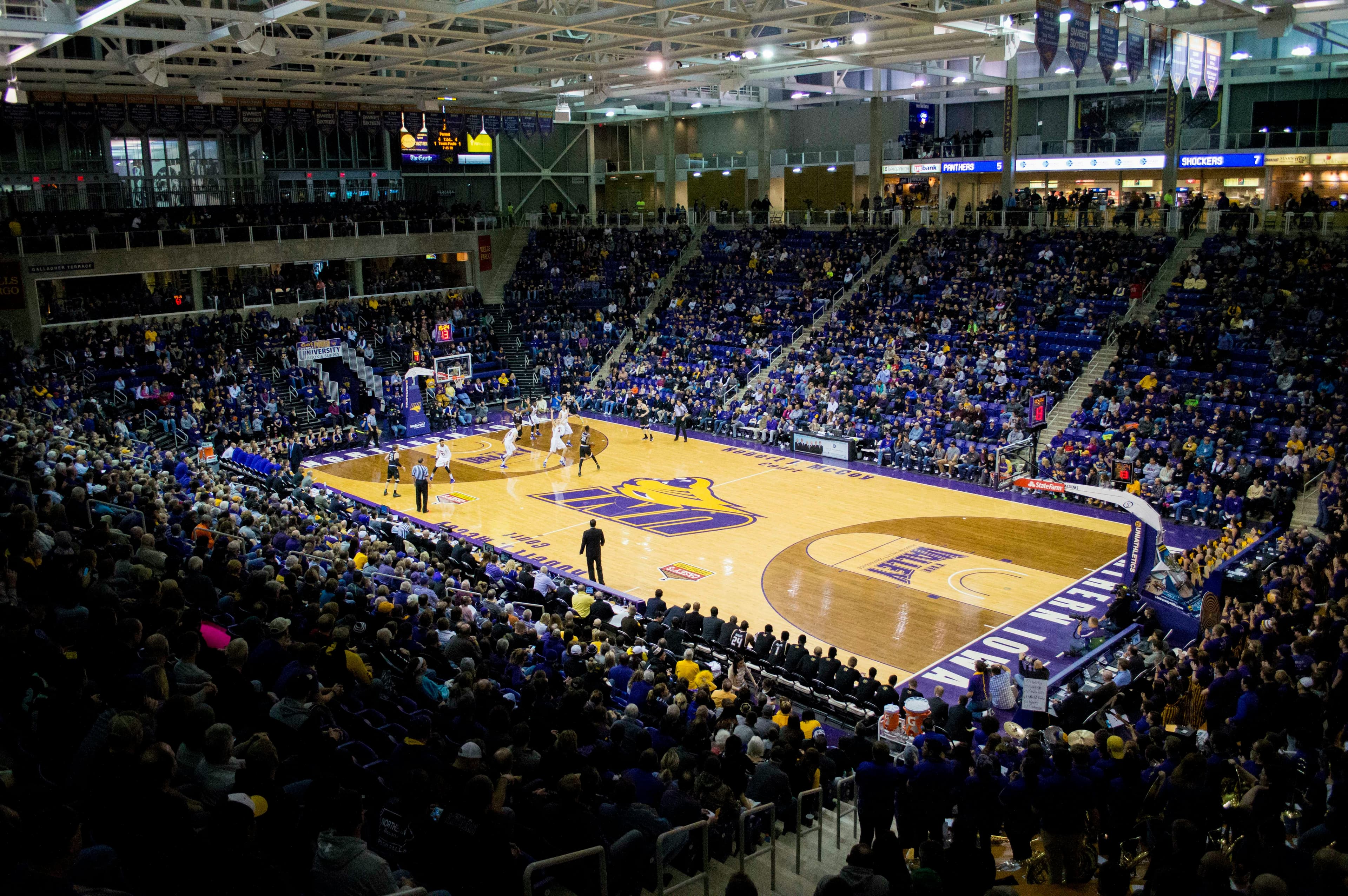 NCAA Division 1 basketball arena packed with fans during a college basketball game