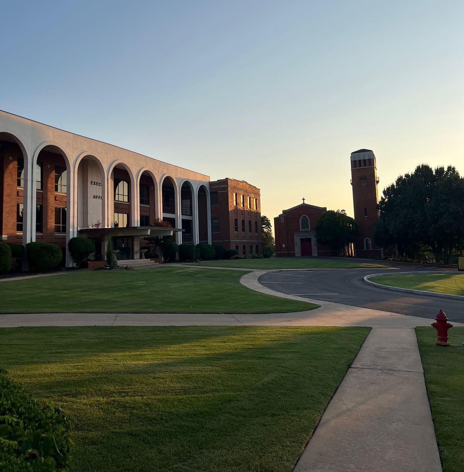 NAIA university campus with modern architecture, green lawn, and elegant columns